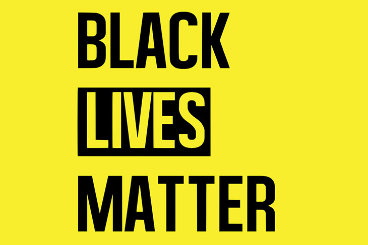 Black Lives Matter logo on yellow background.