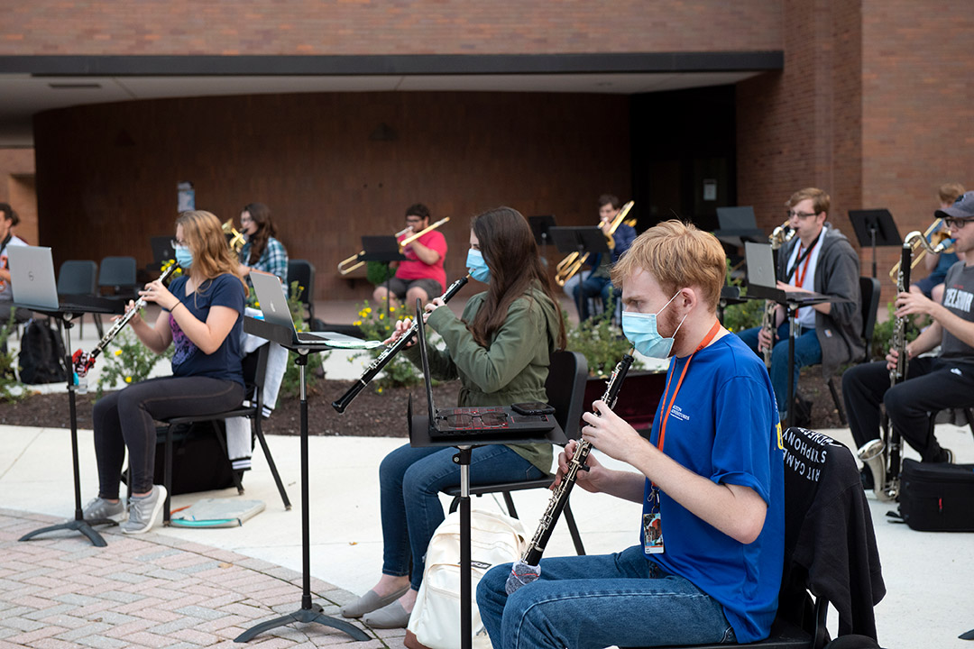 members of concert band practicing outside.