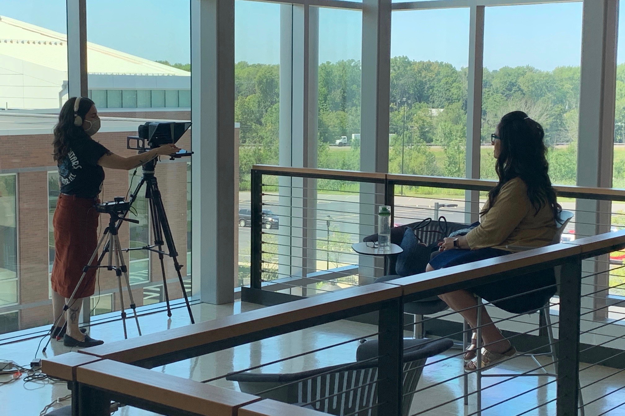 Woman videotaping female faculty member.