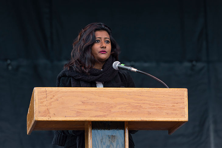 woman speaking at a podium.