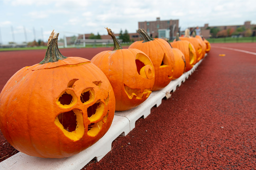 jack-o-lanterns lined up along an outdoor track.