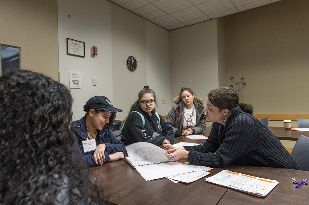 Mindy Magyar reviews portfolios of high school students.