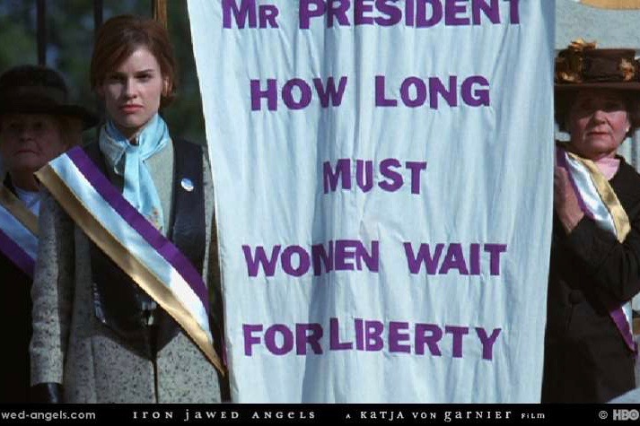 Image from film clip of women holding protest banner