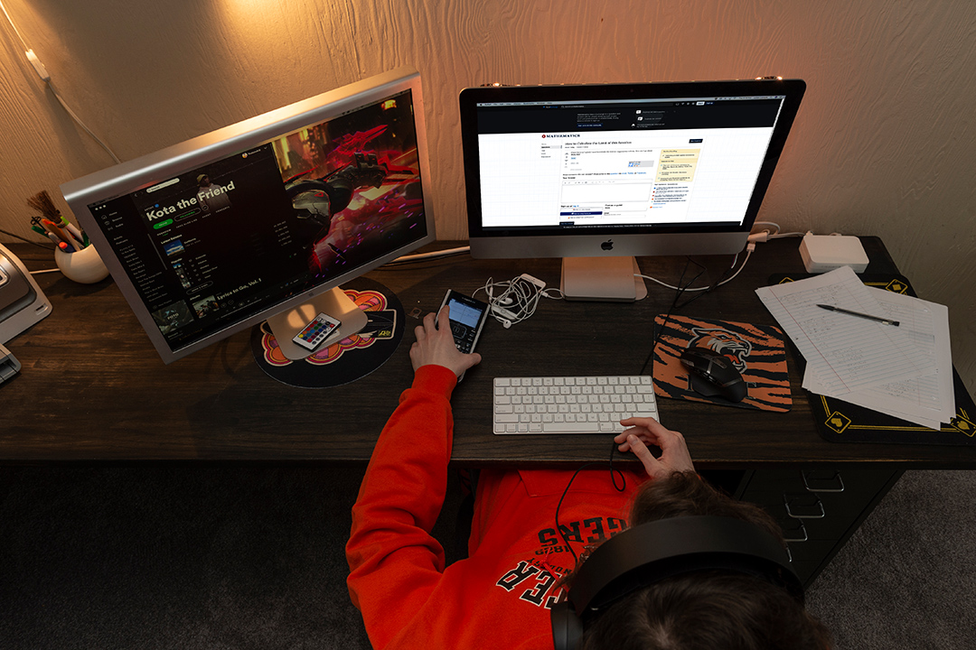 overhead view of student working on computer at home.