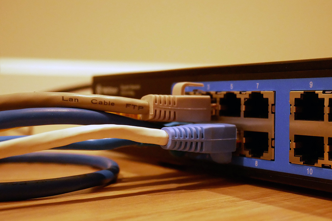 closeup of LAN cable plugged into a router.