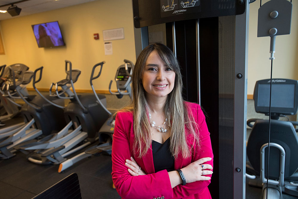 reseacher standing with gym equipment.