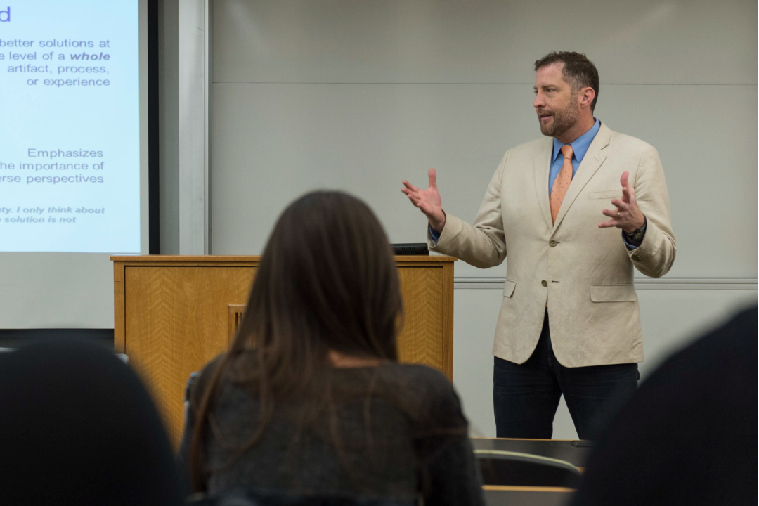 Sean Hansen, Ph.D. speaking in front of a classroom