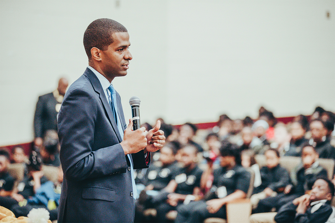 Guest speaker, Bakari Sellers with microphone in front of audience