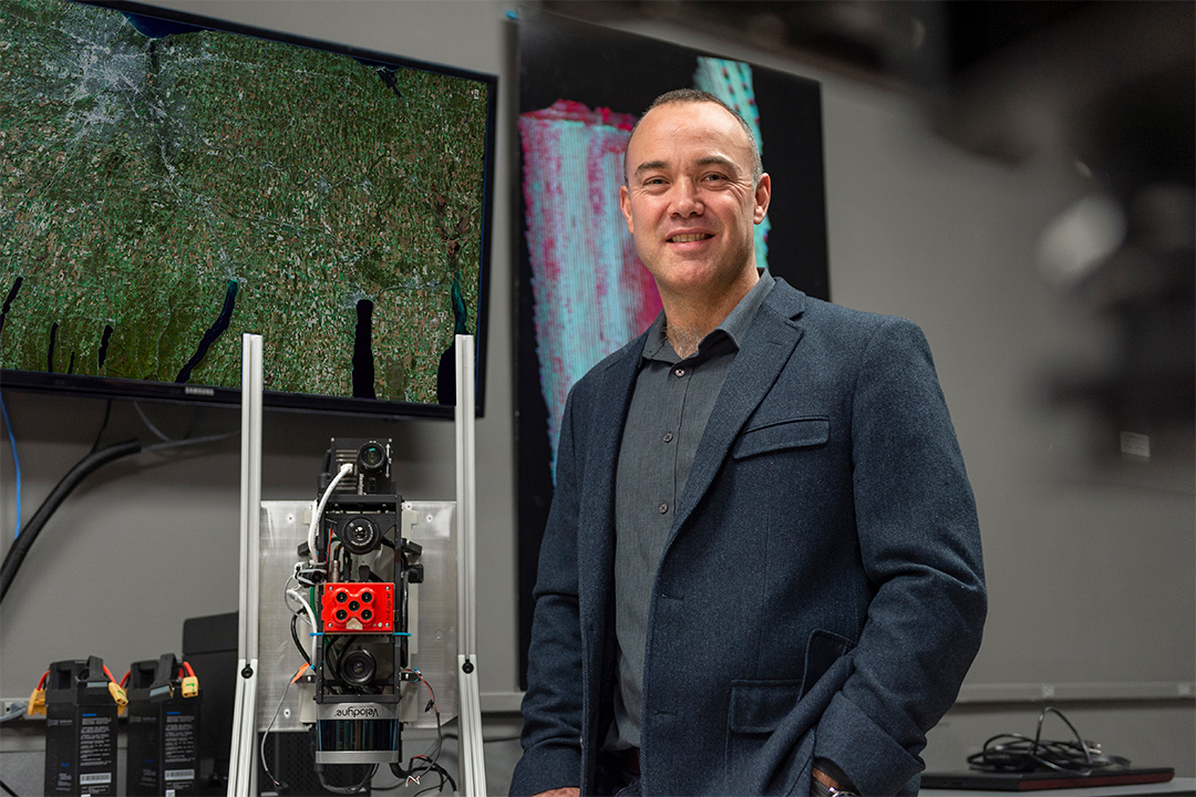 professor posing with a LiDAR camera.