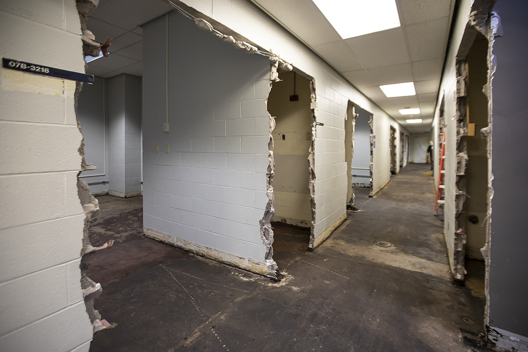 A photo of hallway walls knocked down and getting ready for construction.