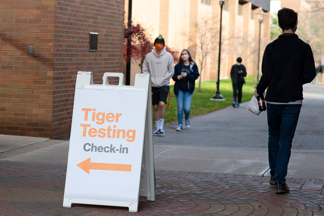 sign outdoors with an arrow and the text "Tiger Testing Check-in."