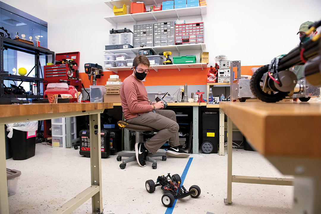 student controlling an RC car with a remote.