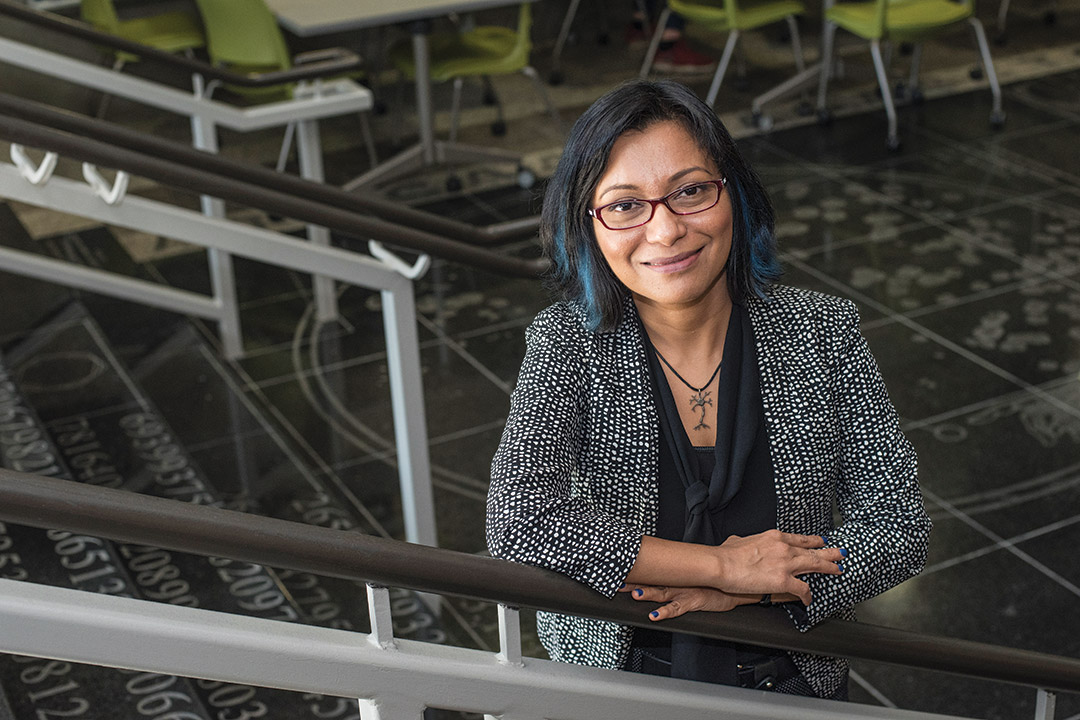 researcher posing on steps in the College of Science.