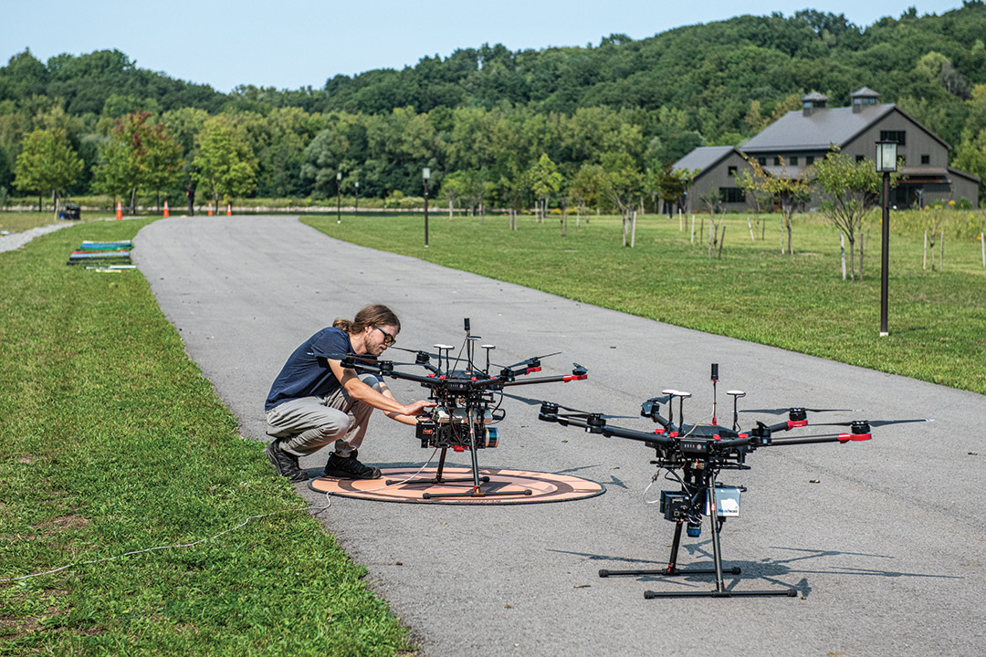 researcher setting up a drone on a roadway.