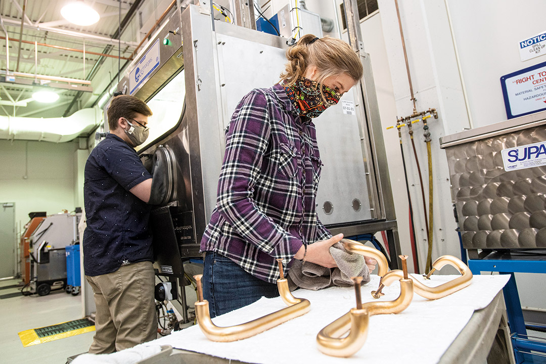 researcher cleaning door handle.