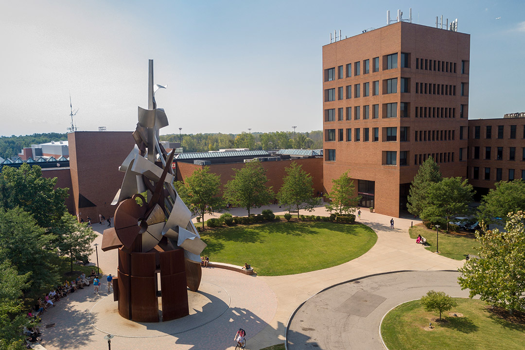 Aerial image of a large sculpture next to several buildings