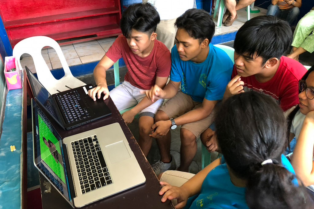 deaf children in the Philippines using laptop computers.