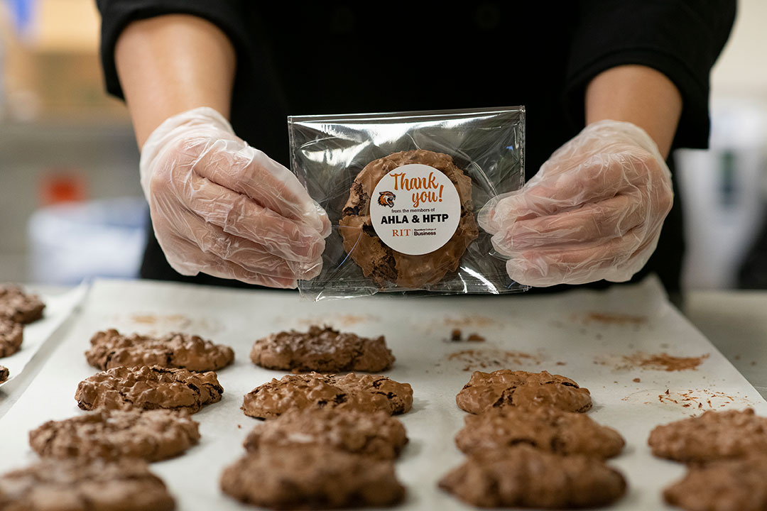 tray of cookies with one in a wrapper.