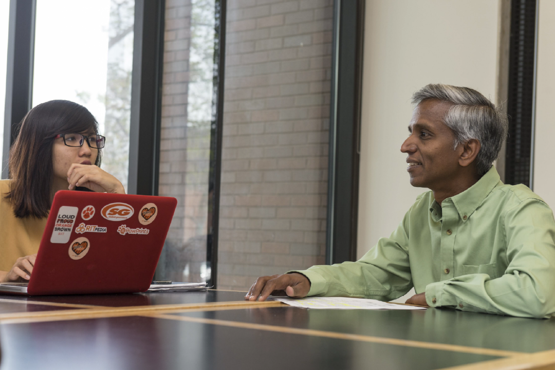 Prof. Ashok Robin coaches a student at Saunders College of Business