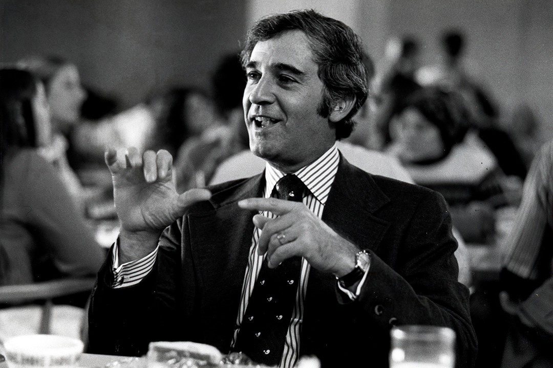 black and white photo of man using sign language.