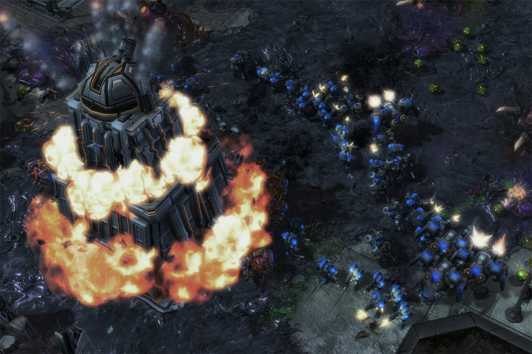 screenshot of building on fire in the video game Starcraft 2.