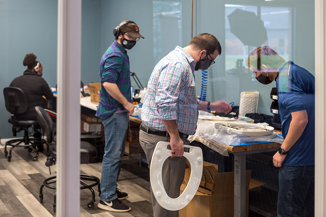 people working on toilet seat prototypes.