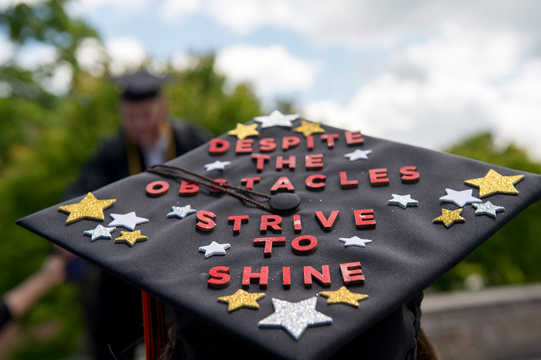 graduation cap that reads: despite the obstacles, strive to shine.