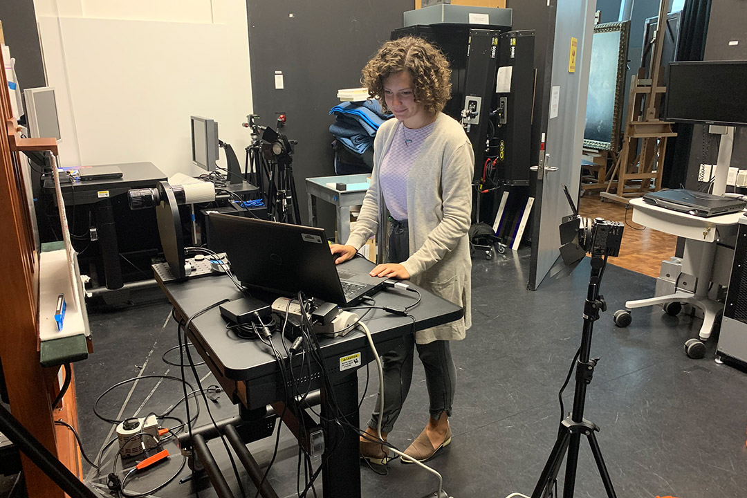 student working on laptop at a standing desk.