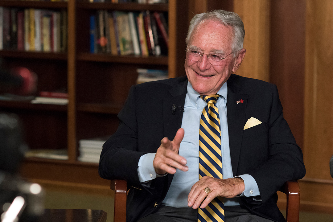 RIT President Emeritus M. Richard Rose sitting in a chair.