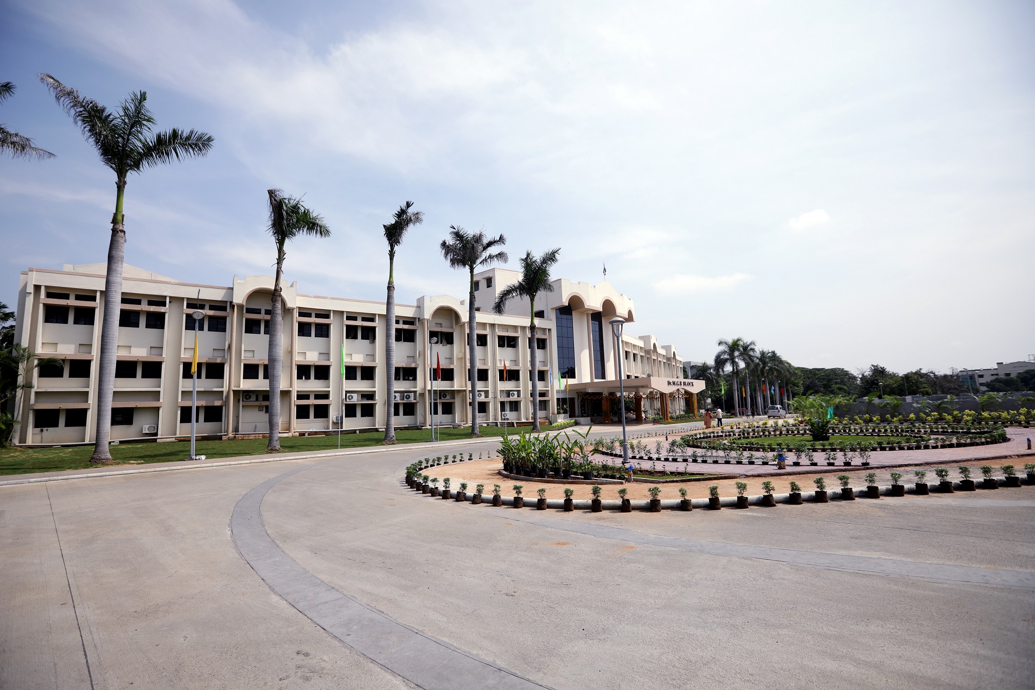 Vellore Institute of Technology (VIT) campus in India. White building with palm trees. 