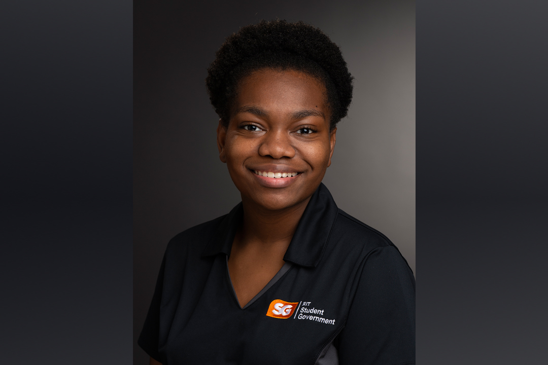 Young woman with RIT Student Government logo on her polo shirt