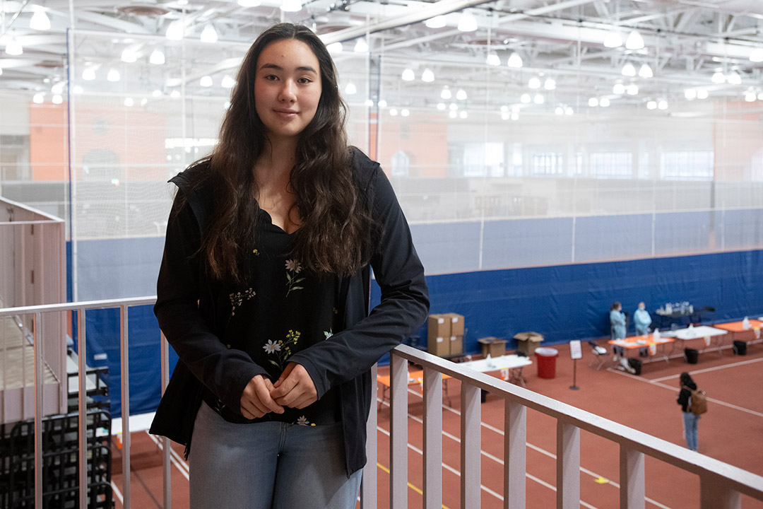 student standing on second level of field house.