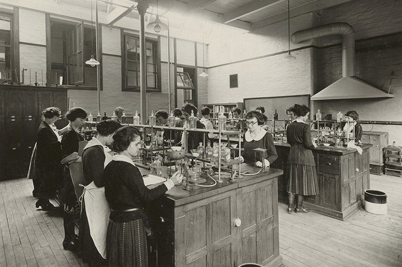 students working in a science lab around 1900-1920.