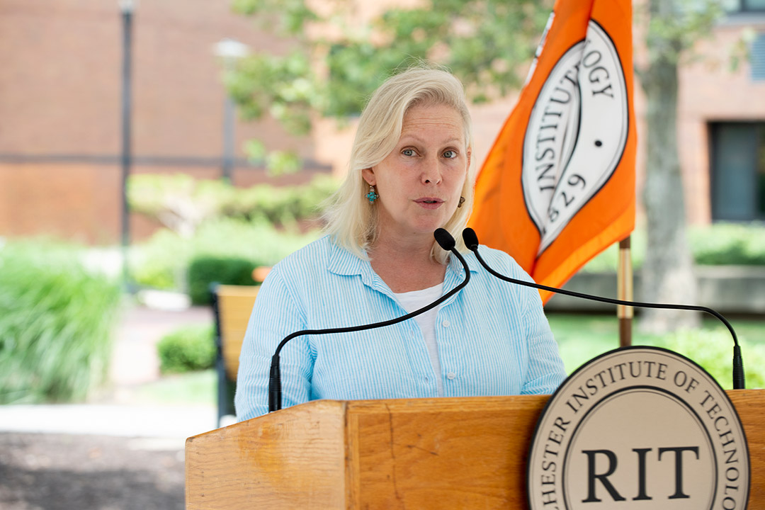 Senator Kirsten Gillibrand speaking at a podium outdoors.