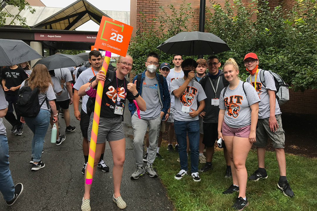 group of college students outside with their orientation leader.