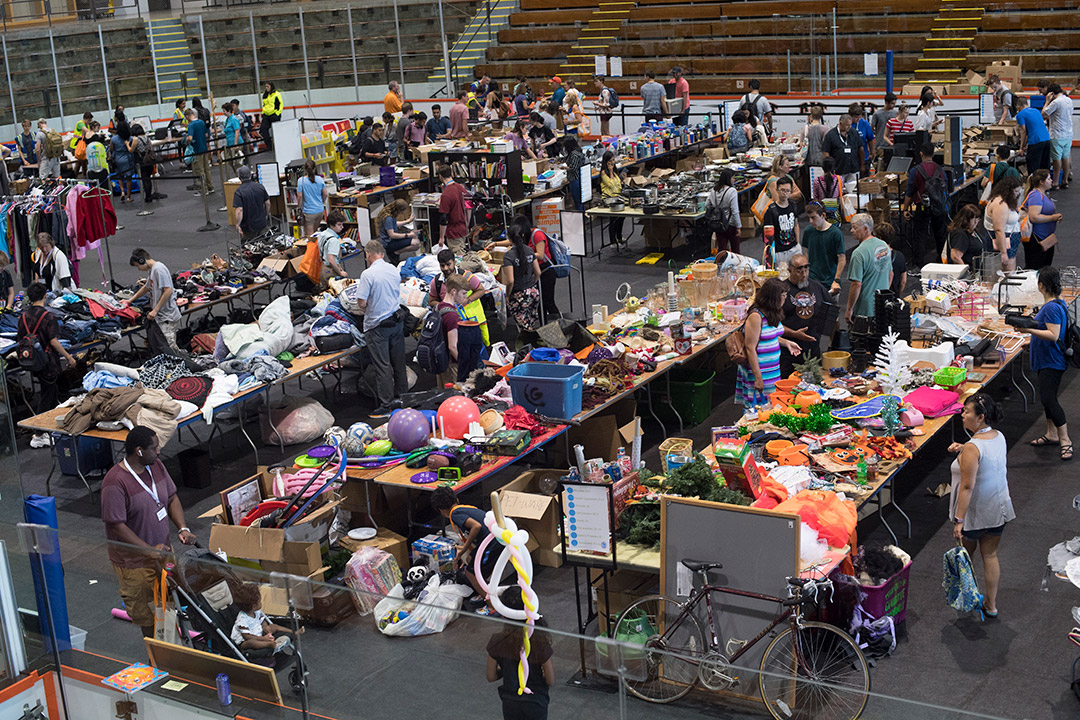 ice arena filled with people shopping for used goods.