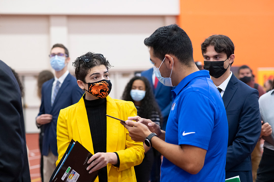 people talking at a career fair.