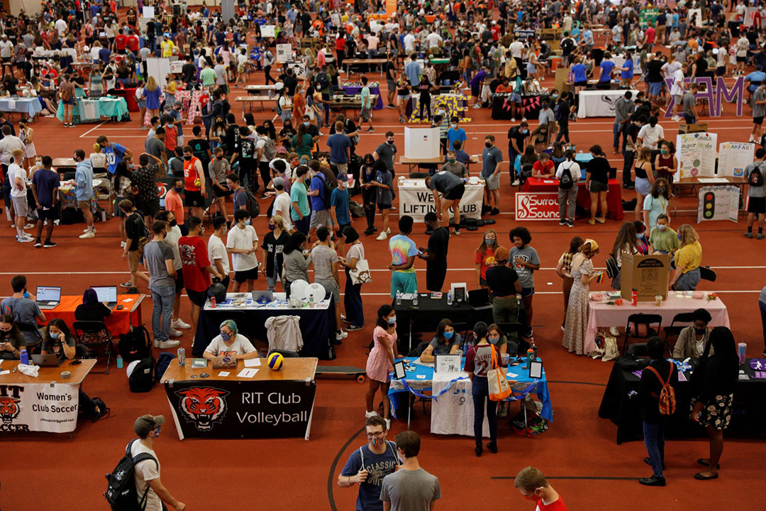 crowds of students visiting tables representing RIT's clubs.