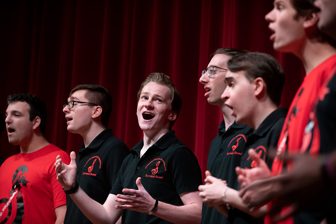 six students singing in an a cappella group.