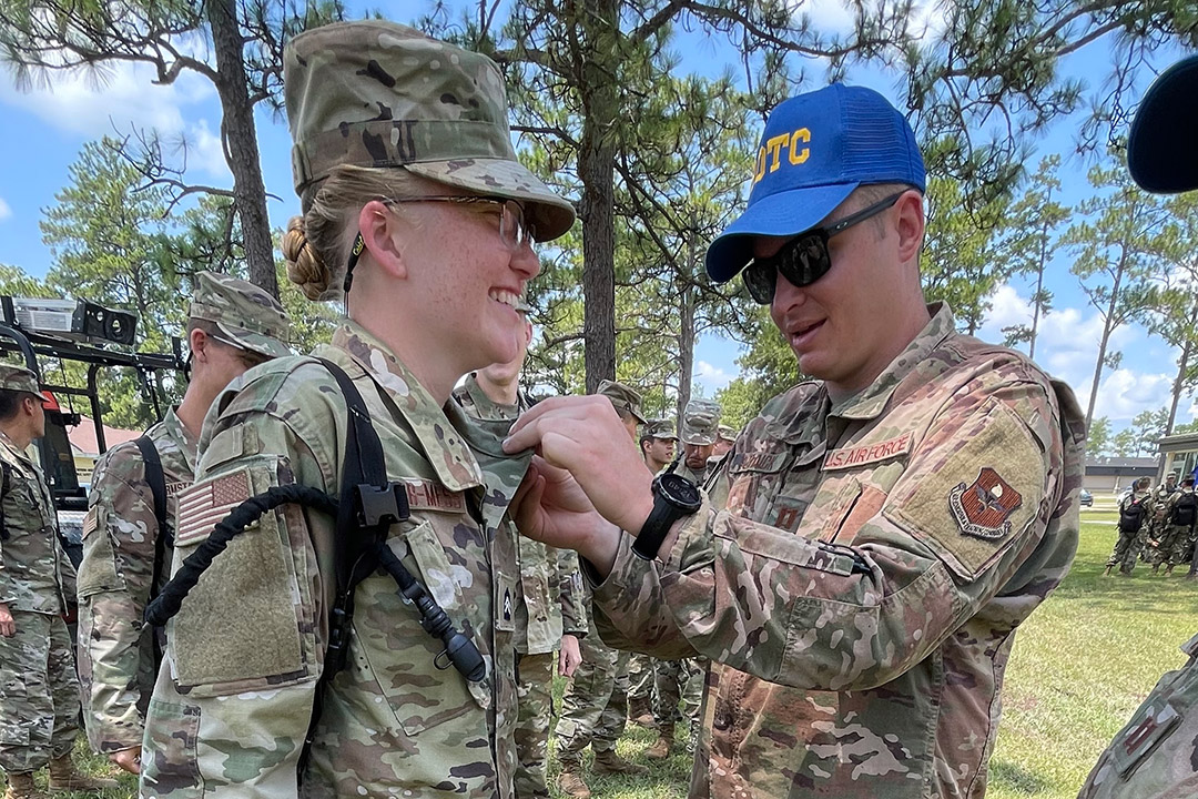 ROTC cadet receiving insignia for the Professional Officer Course.