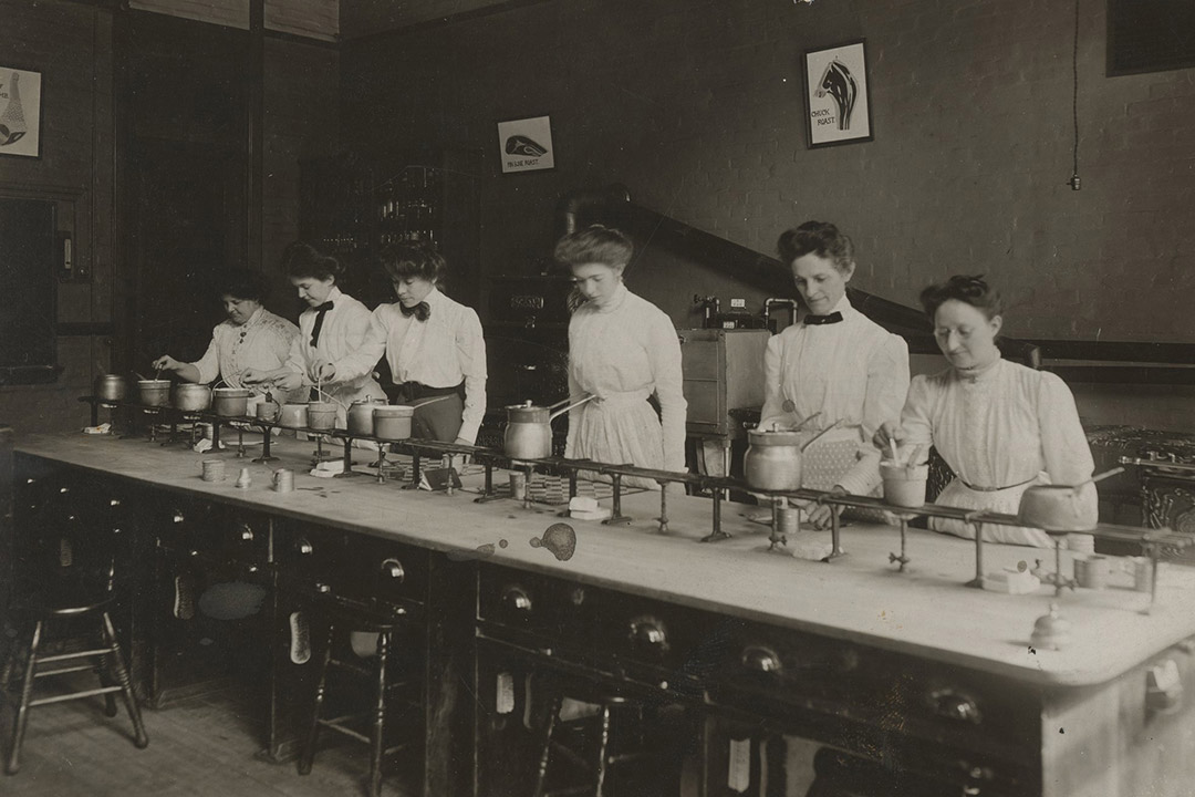 historic photo of women in a cooking lab.