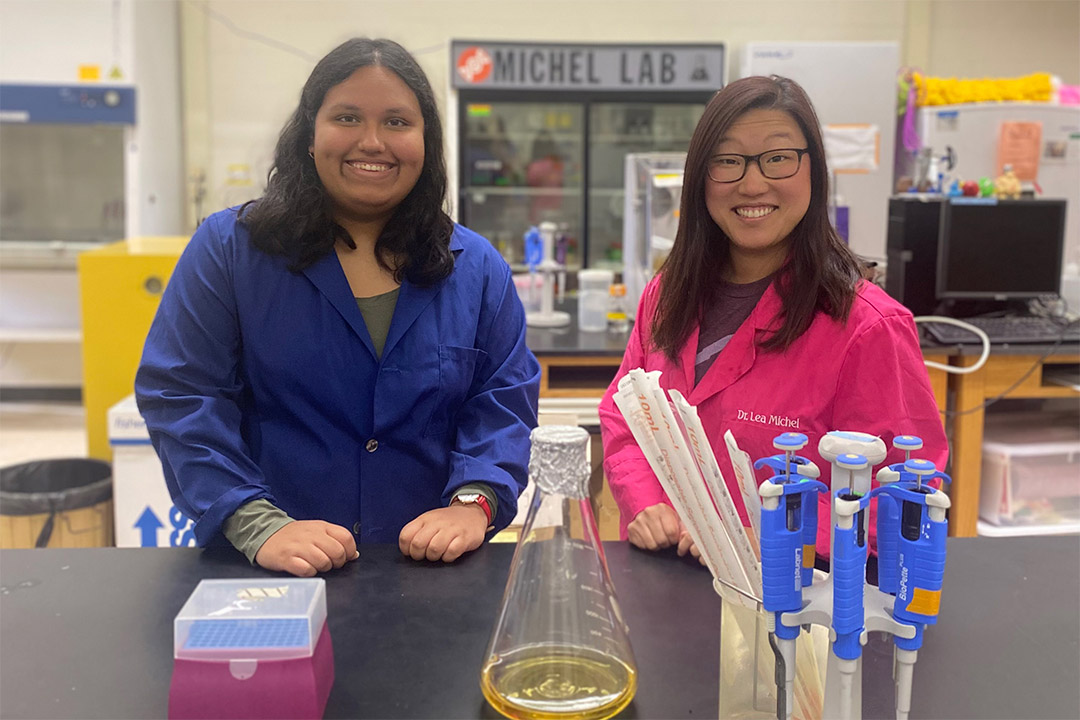 student and professor in a lab.