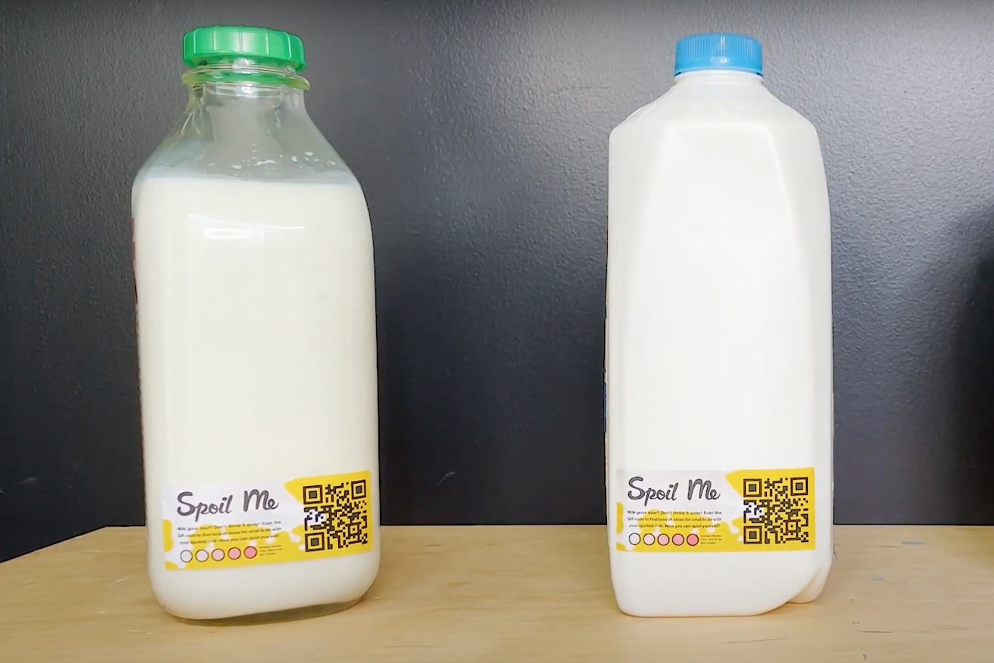 Two milk cartons with special labels that direct people to a website with recipes for spoiled milk.