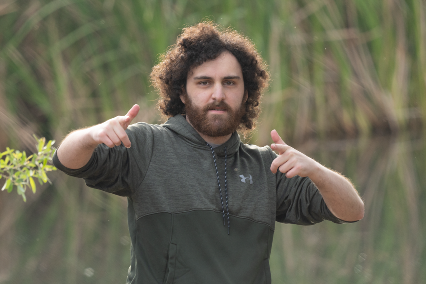A portrait of Joey Wittmann pointing at the camera.