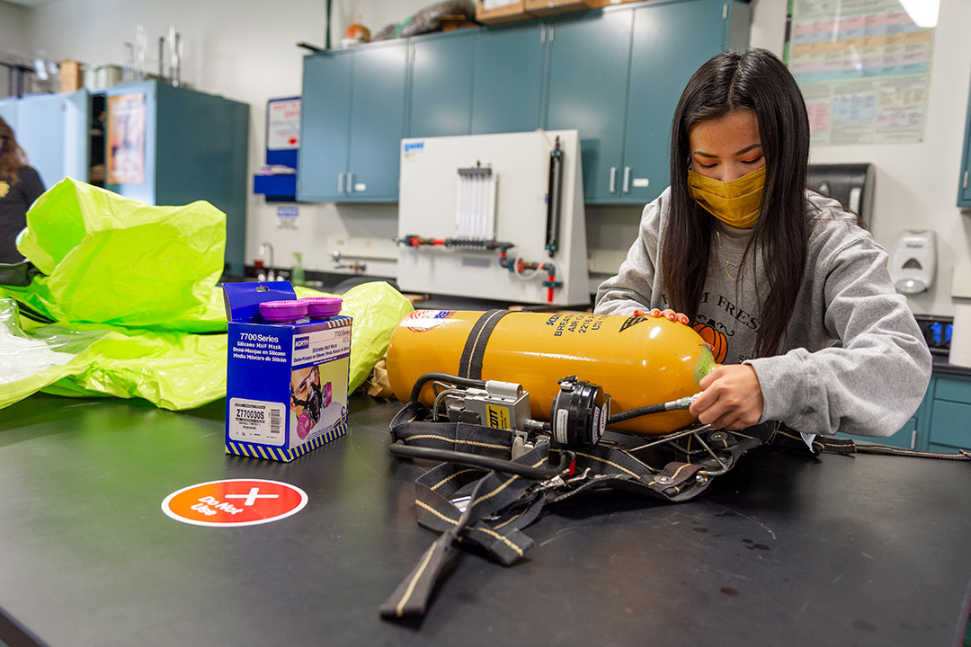 student works on project with an air tank.