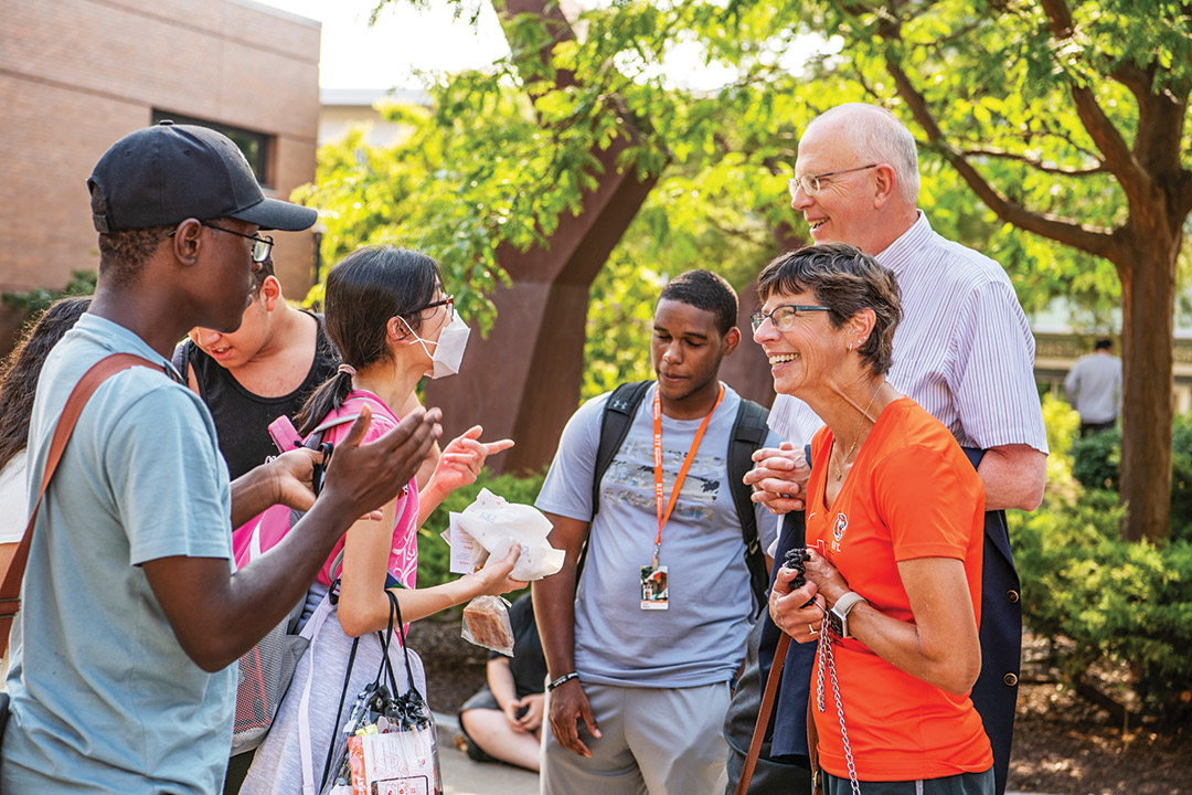 RIT president and his wife talking to students.