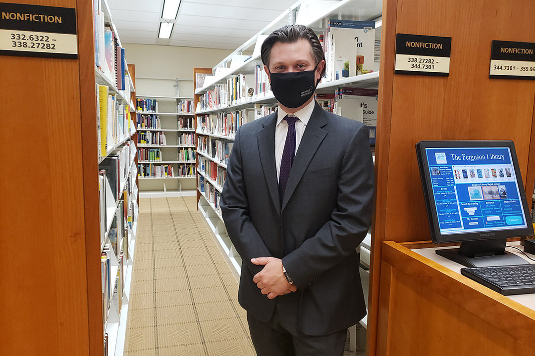 a lawyer standing in a library.