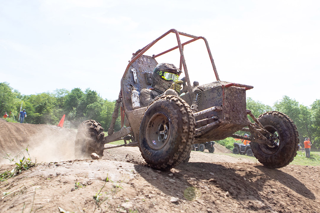 baja off-road vehicle cresting a hill.