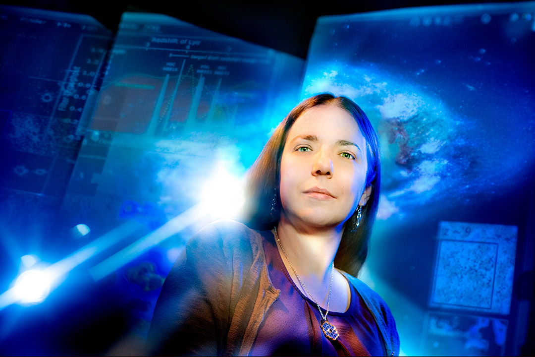 environmental portrait of professor Jeyhan Kartaltepe in front of images of space.