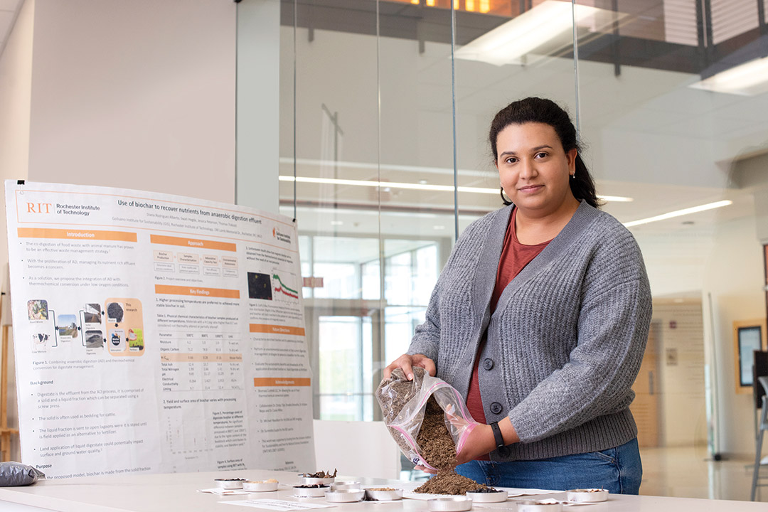 researcher with different samples of organic materials called biochar.